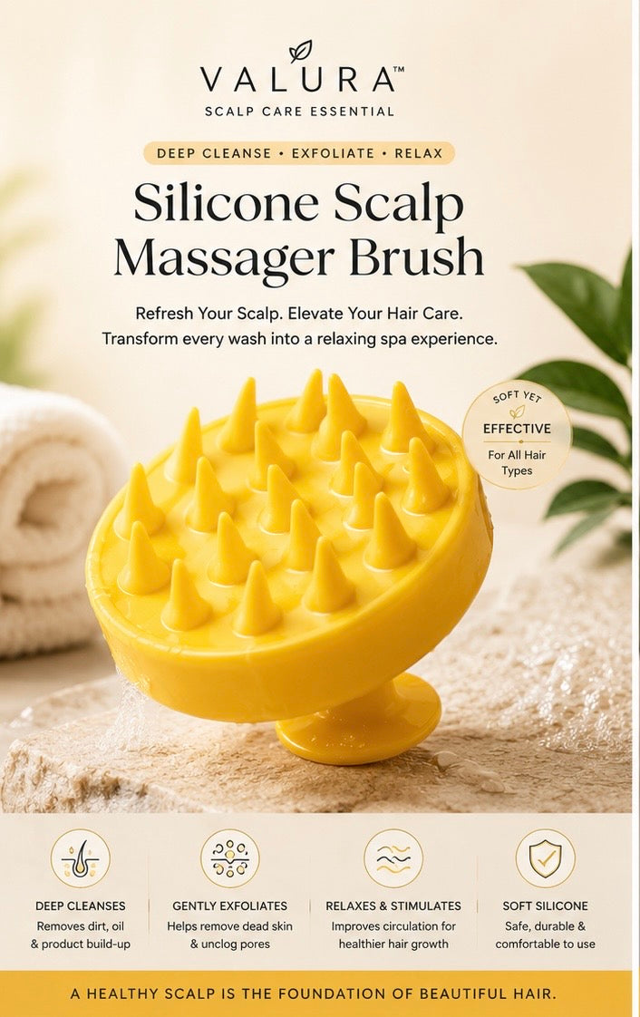 A yellow silicone scalp massager brush by Valura, shown on a beige spa-themed background with a rolled towel and green leaves. The image includes product text, benefits icons, and the Valura brand logo.